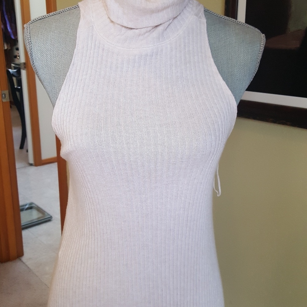 Sleeveless turtle neck in cream. Gently worn.